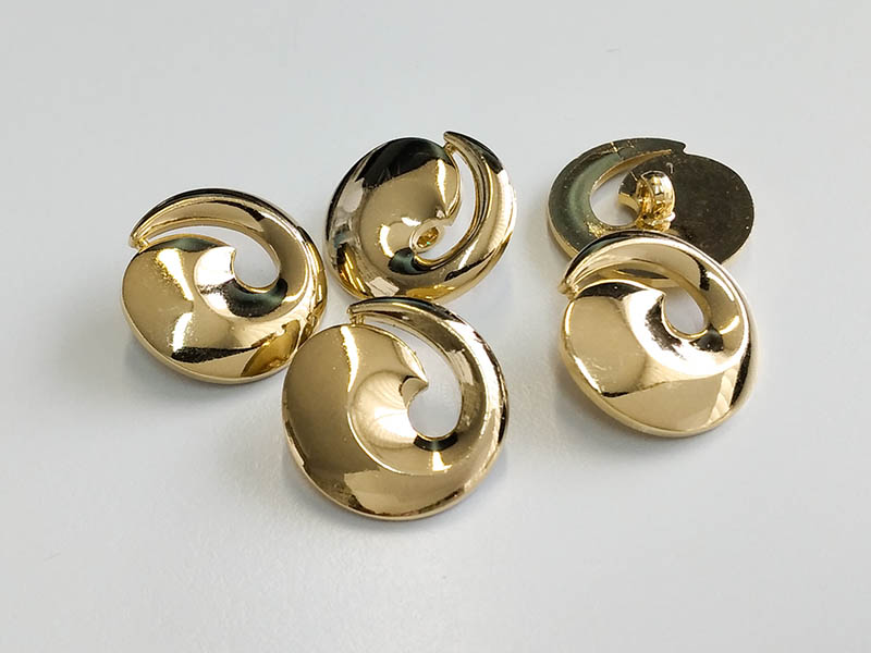 www.knopfparadies.de - 3903go - Glänzend goldfarbene Kunststoffknöpfe in Spiralform
