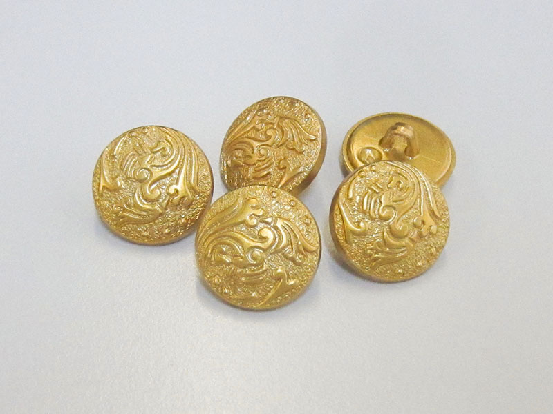 Günstigere goldfarbene Ösen Kunststoffknöpfe mit abstraktem floralem Motiv / B-WARE