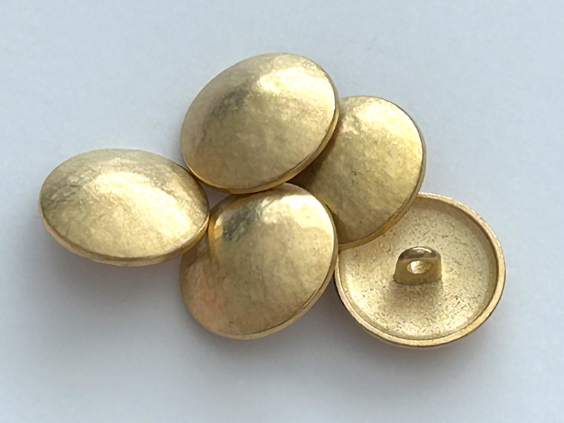 Klassischer Uniformknopf in matt gold, wie gehämmert wirkend