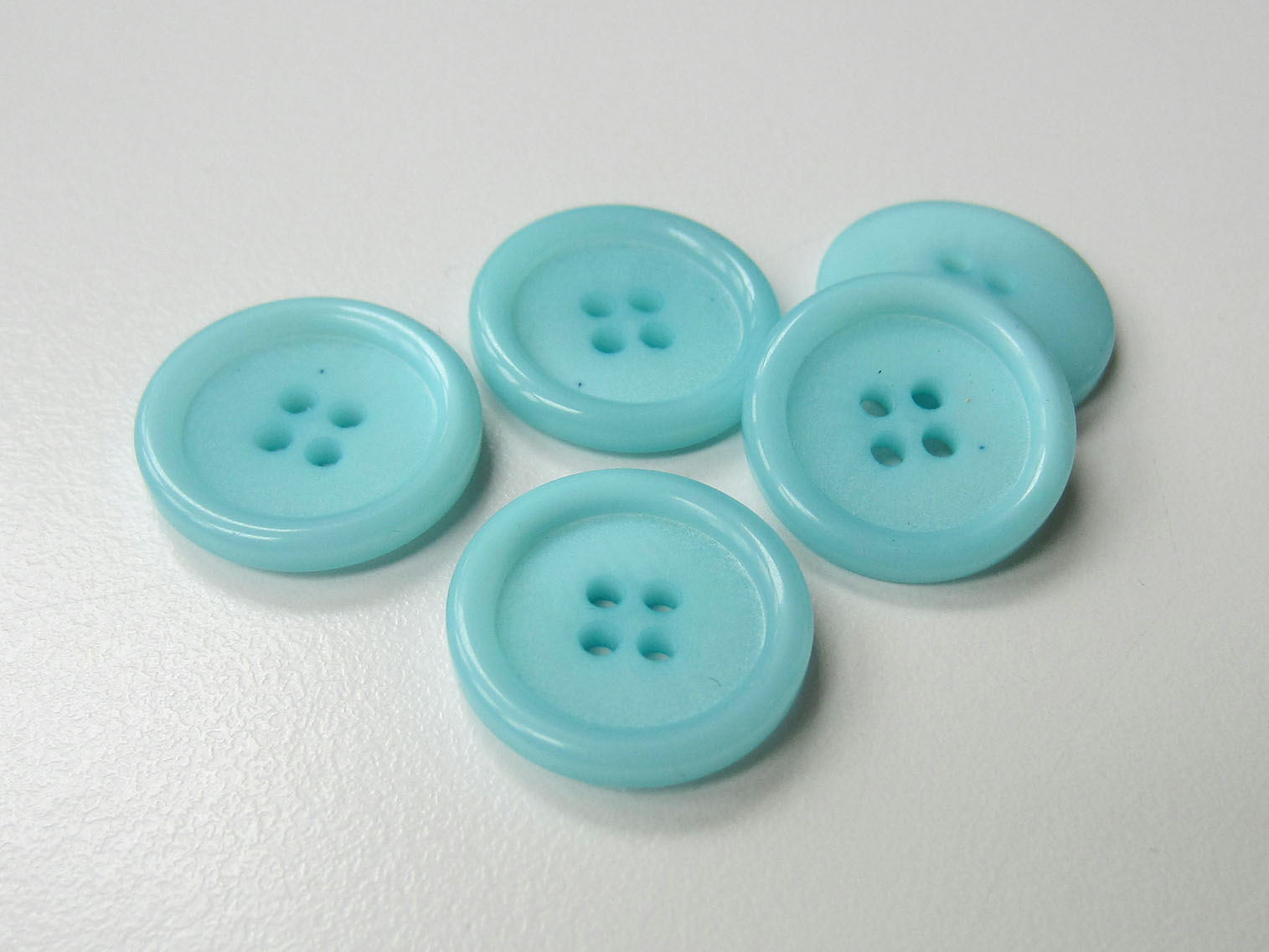 Hübscher hell türkis blauer Vierloch Kunststoff Knopf