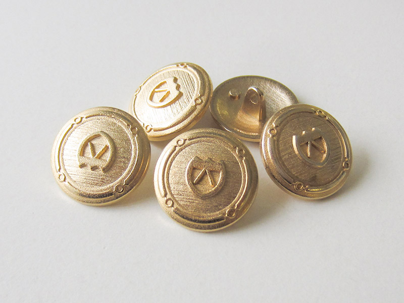 Graphischer Wappen Metall Knopf in Goldfarben