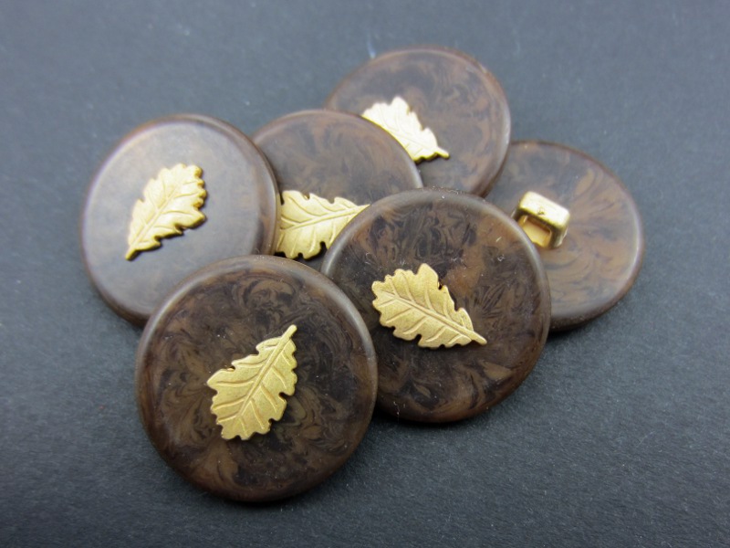 Brauner Knopf mit goldenem Eichenblatt