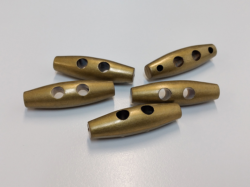 www.knopfparadies.de - 5524ag - Altgold- bis messingfarbene Knebelknöpfe aus Kunststoff