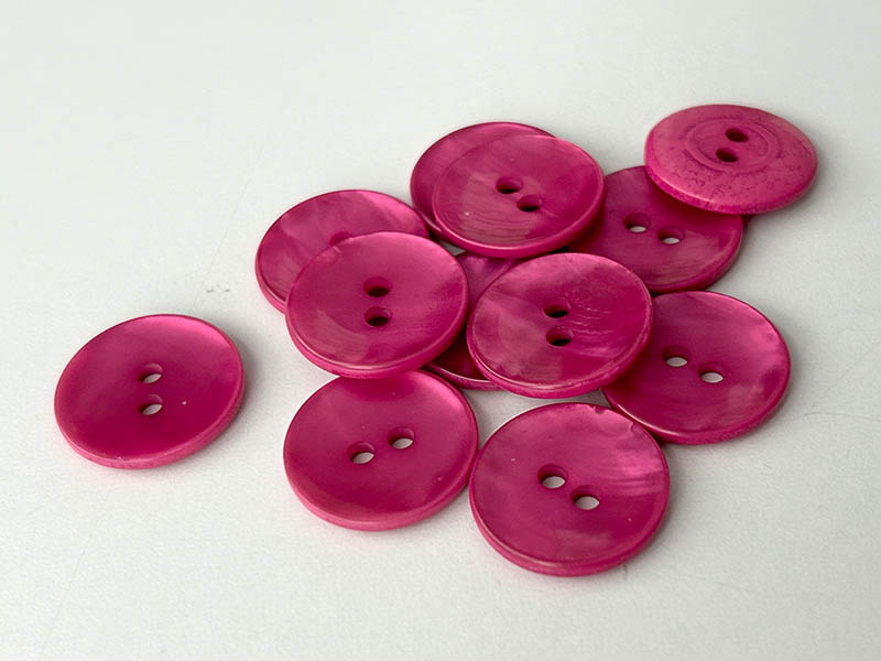 Pinkfarbene Kunststoffknöpfe in Perlmuttoptik