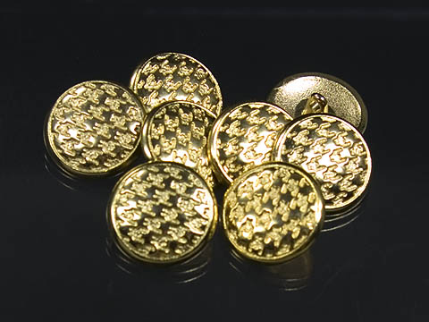 Goldfarbene Metallknöpfe mit Hahnentrittmuster