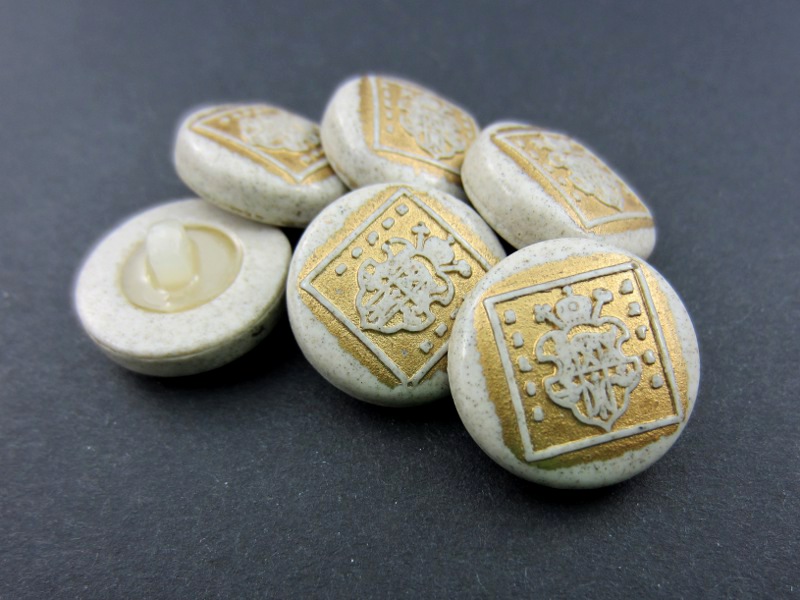 Beige grau goldfarbener Knopf mit Wappen