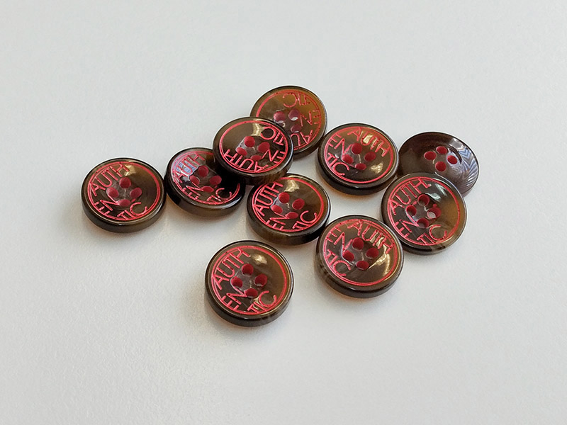 Runder Blusenknopf in Hornoptik mit roter AUTHENTIC-Inschrift – 4-Loch