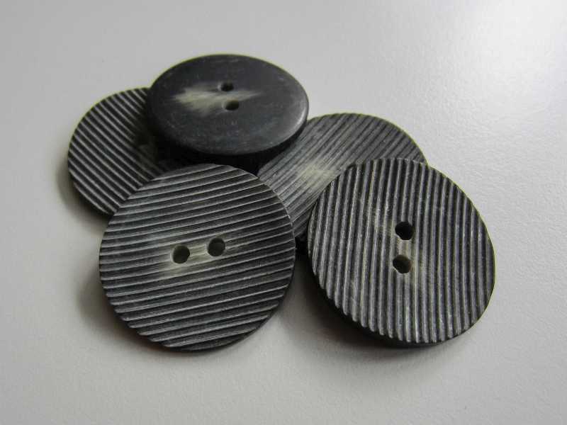 Graubrauner Zweilochknopf mit zarter Riefelung