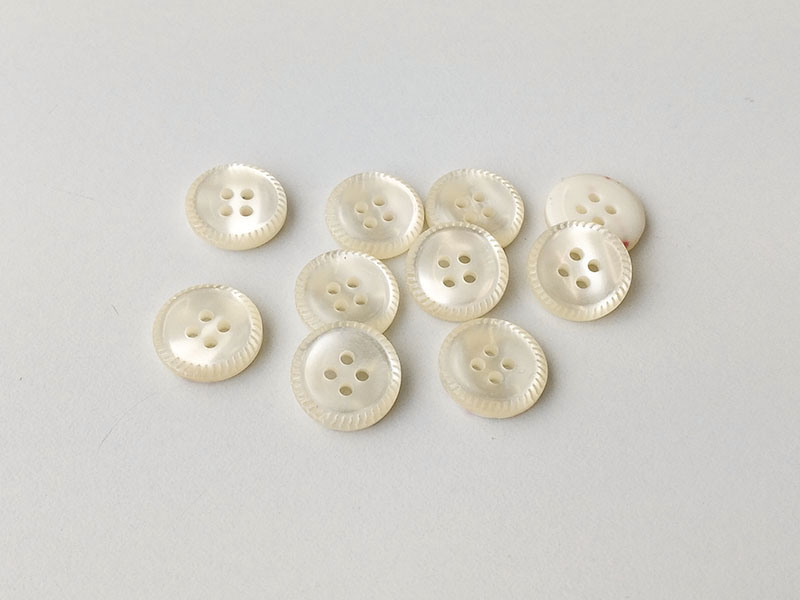www.knopfparadies.de - 6043nw - Naturweiß schimmernde Kunststoffknöpfe mit vier Löchern und hübschem Rand